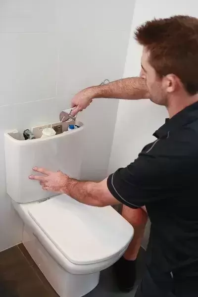 handyman fixing toilet